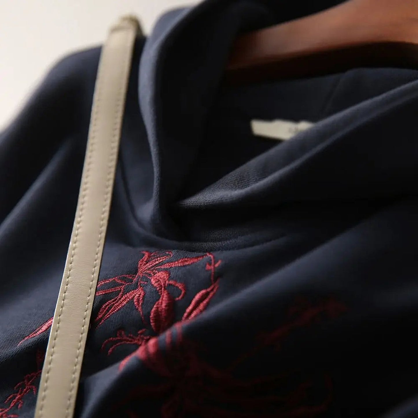 Navy embroidered graphic hoodie for women featuring delicate floral design and cozy fabric