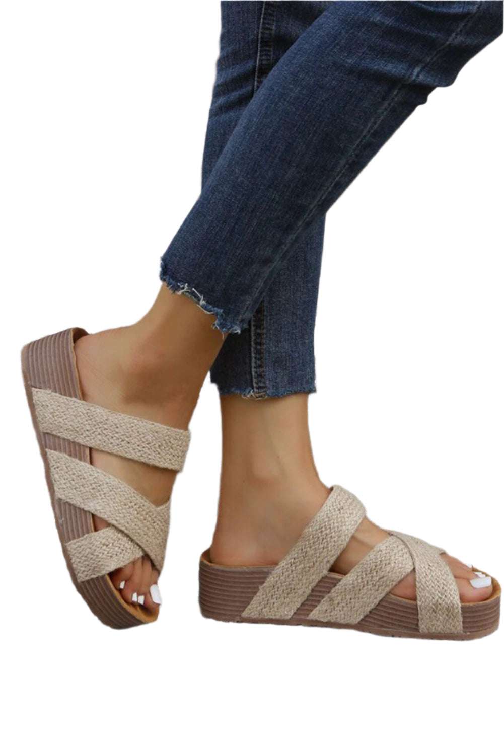 Beige woven slip-on sandals by LuckeLadybug LLC worn with dark blue jeans