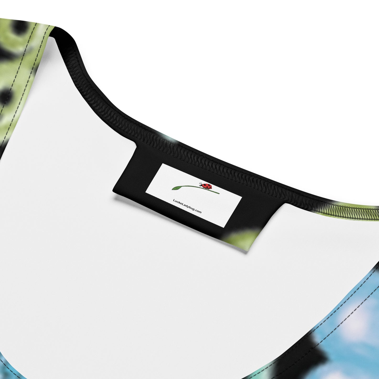 Close-up of LuckeLadybug black paisley bodycon dress neckline with label detail