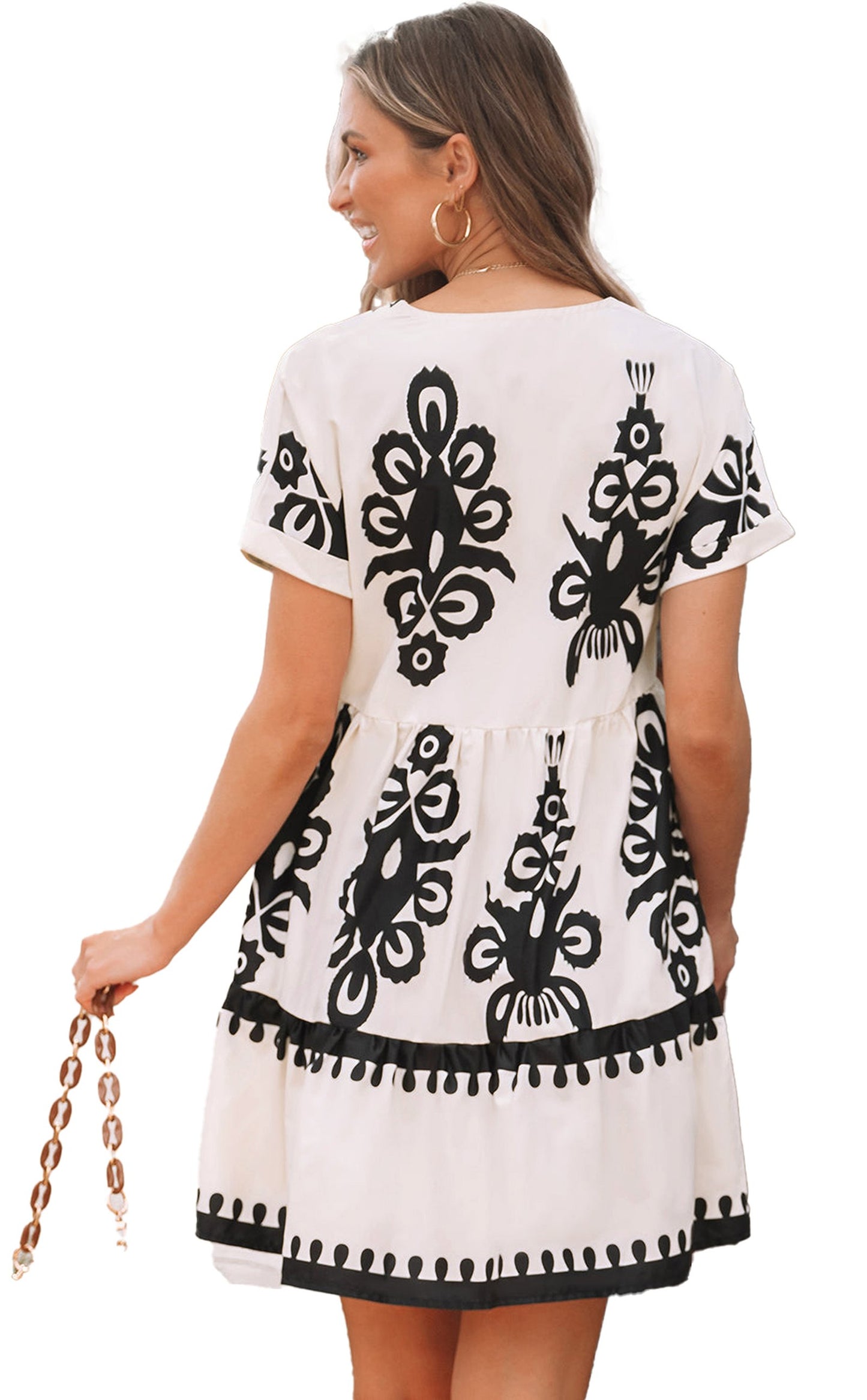 Back view of a black vintage print v neck dress by LuckeLadybug featuring a tiered design and short sleeves