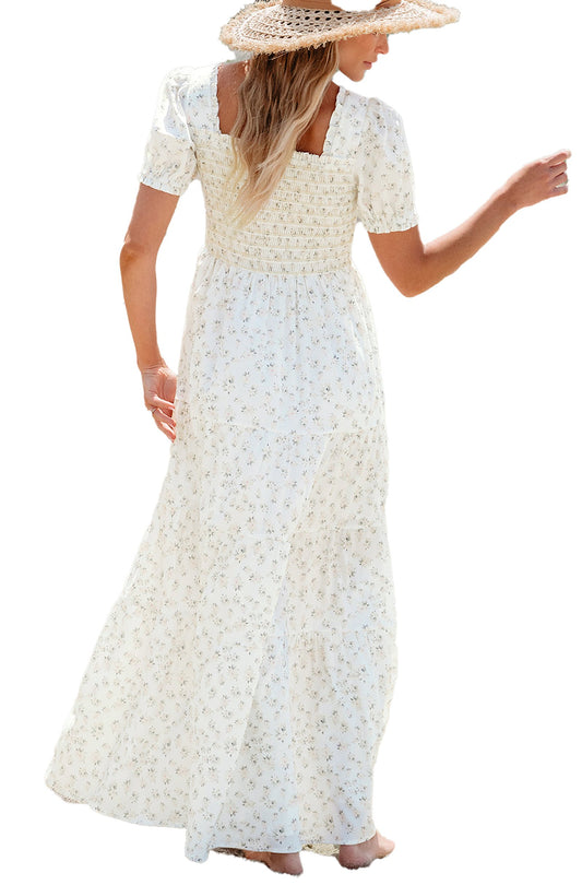 LuckeLadybug white floral maxi dress with smocked bodice and puff sleeves shown on beach with straw hat