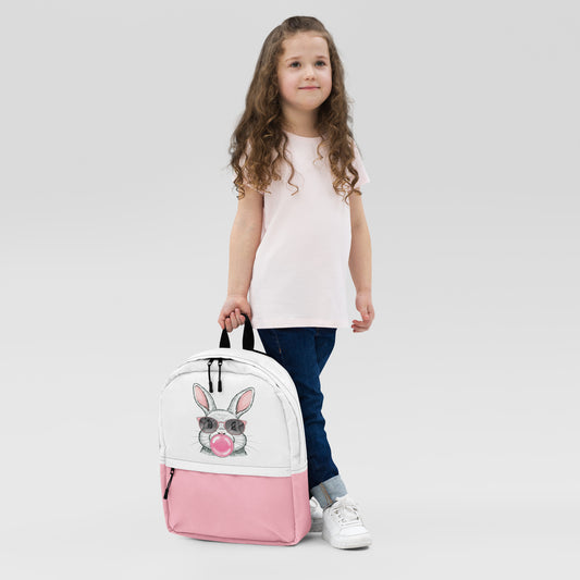 Girl holding colorful bunny backpack with sunglasses and bubblegum design in white and pink