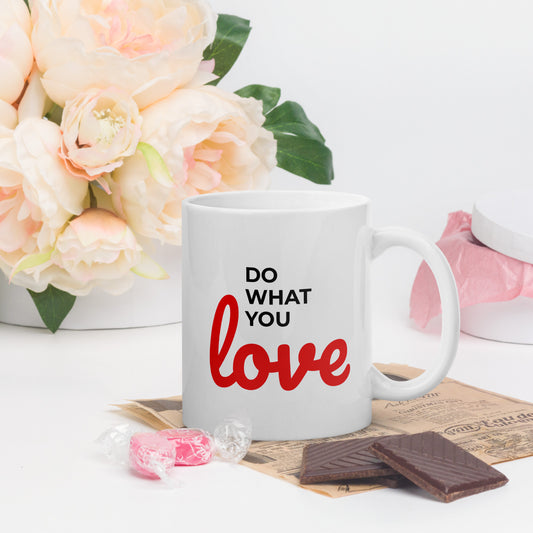 LuckeLadybug do what you love coffee mug with red and black text next to candy and chocolate