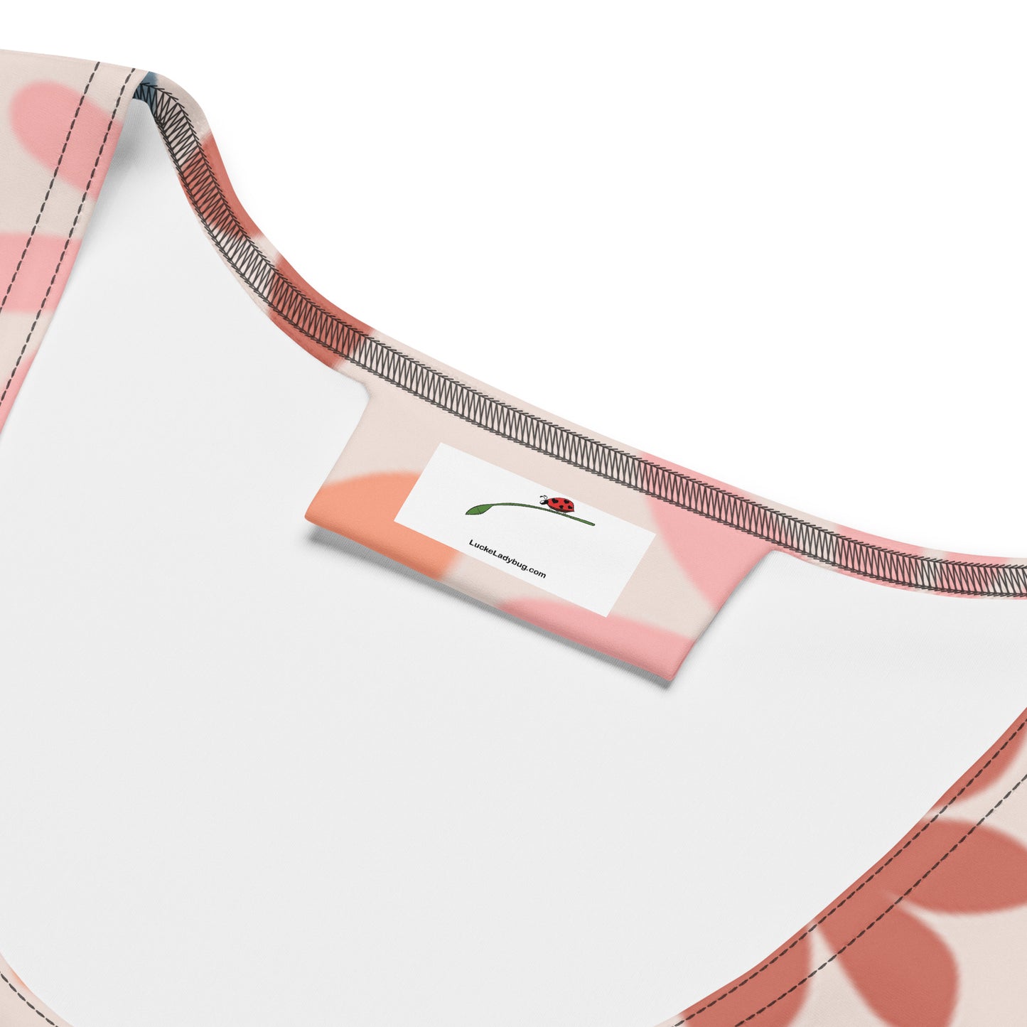 Close-up of LuckeLadybug elegant floral print dress neckline and label inside the bodycon dress