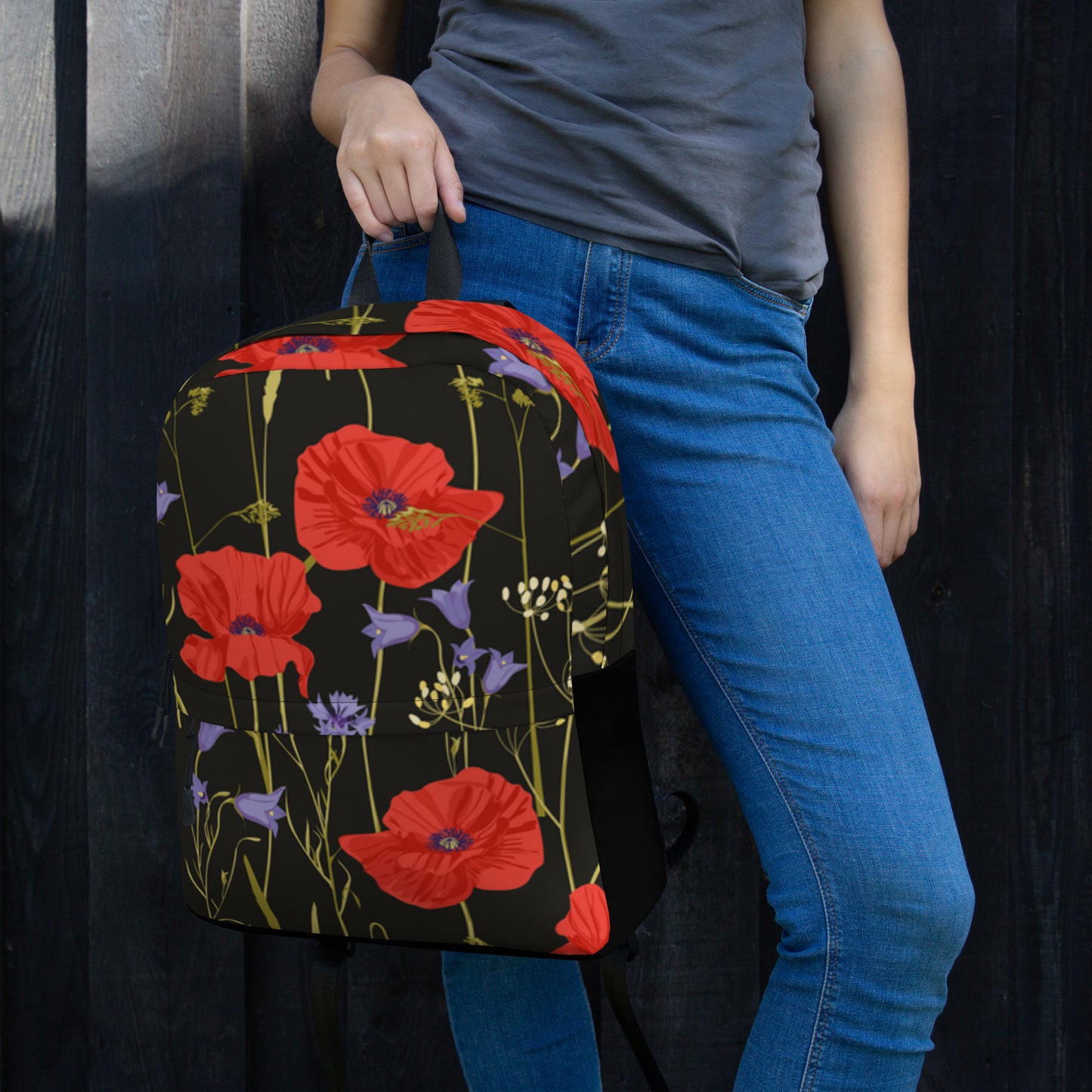 LuckeLadybug floral backpack for women with red poppy and purple flower print held by a woman