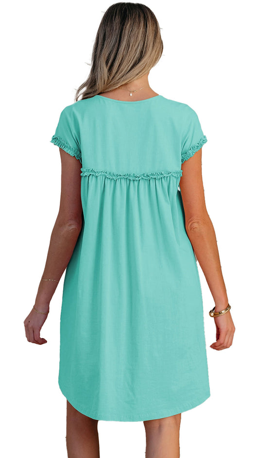 Back view of a mint green mini dress with a relaxed fit and ruffled detailing from LuckeLadybug