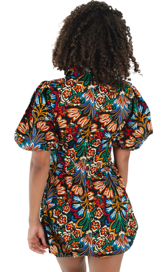 Back view of LuckeLadybug multicolor floral puff sleeve dress showcasing vibrant floral patterns and a fitted silhouette