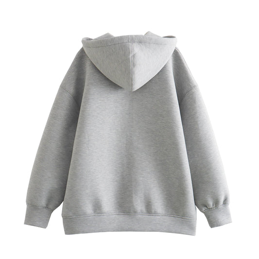 Back view of a gray oversized zip up hoodie for women with a cozy hood and wide sleeves