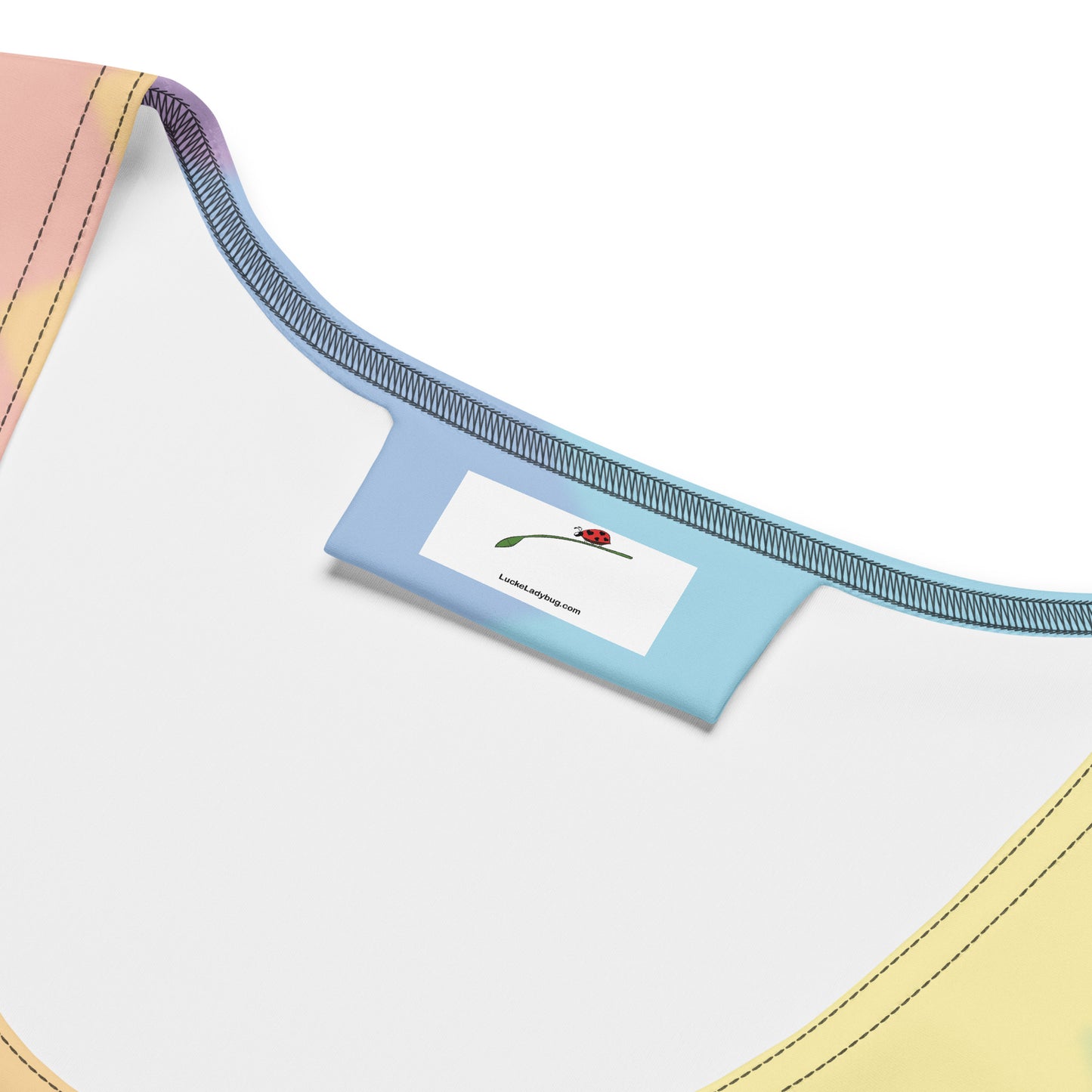 Close-up of LuckeLadybug rainbow bodycon dress neckline and brand label inside the garment