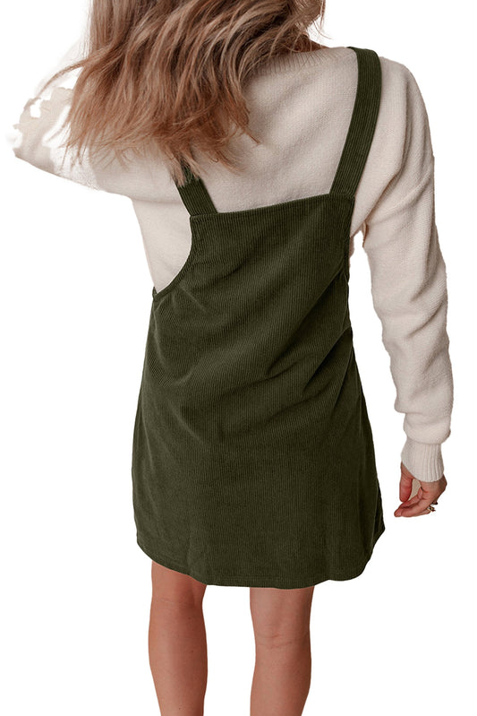 LuckeLadybug back view vineyard green corduroy overall dress over cream sweater mini length adjustable straps