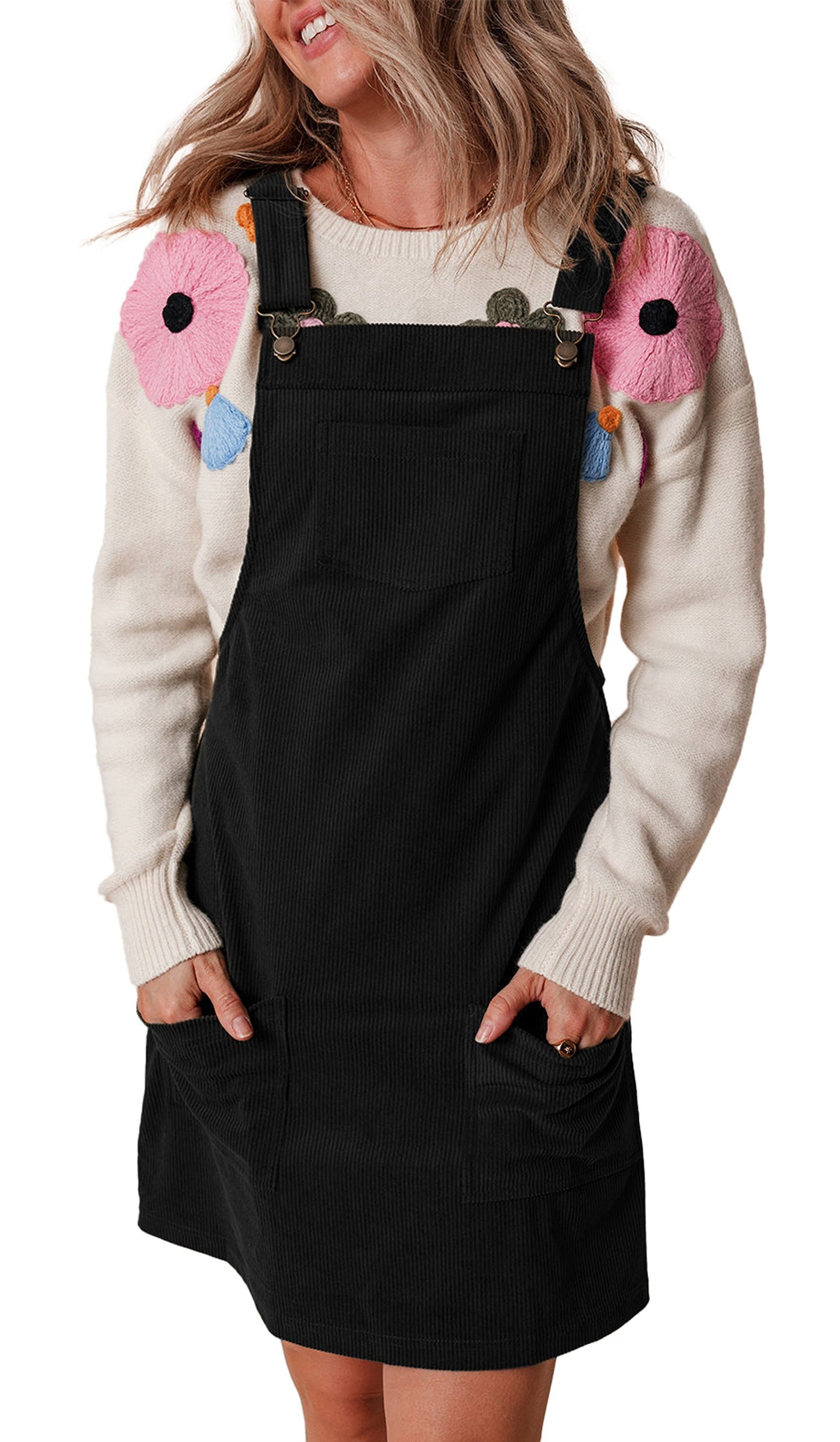 Model wearing LuckeLadybug vineyard green corduroy overall dress styled here in dark corduroy over a floral applique sweater