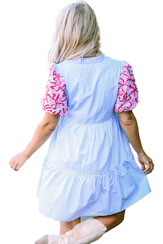 Back view of a sky blue striped floral dress with colorful puff sleeves for a casual summer look
