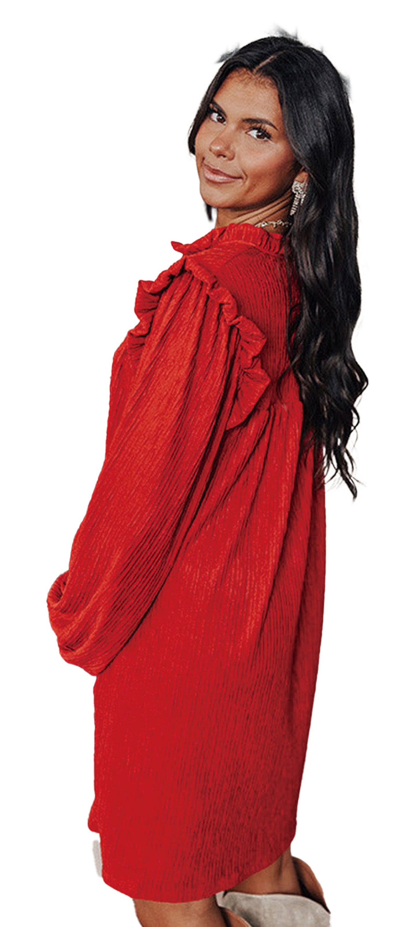 LuckeLadybug model wearing fiery red ruffled mini dress in cozy living room with decorated Christmas tree