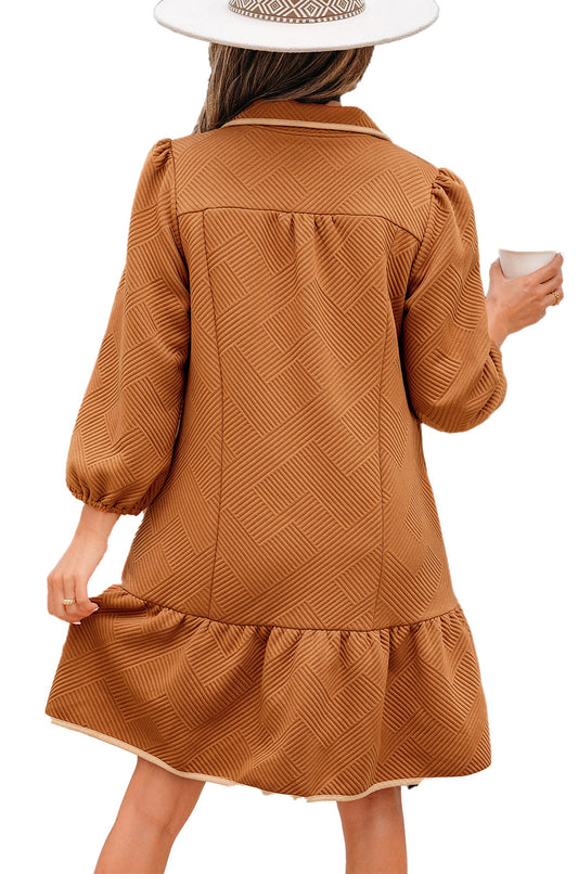Back view of model in LuckeLadybug desert gold quarter zip mini dress textured chevron fabric puff sleeves