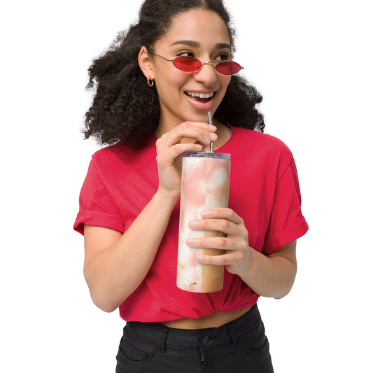 Woman holding tie dye stainless steel tumbler with straw wearing red shirt and sunglasses