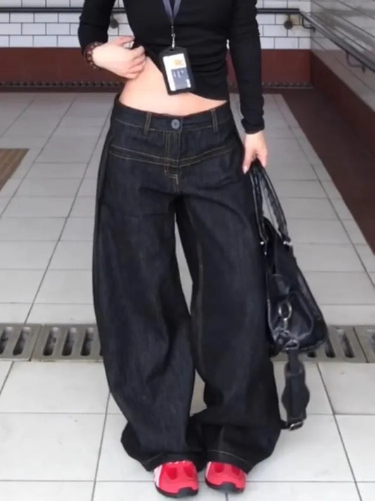 Women wearing vintage washed wide leg jeans women with a black top and sneakers for a casual look