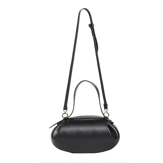 Women's crossbody round bag in black with adjustable strap and stylish design by LuckeLadybug LLC