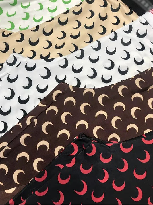 Variety of women’s printed elastic jumpsuit fabrics with crescent moon patterns in multiple colors