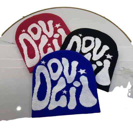 Colorful Y2K beanies for women and men in pink, black, and blue featuring bold graphics