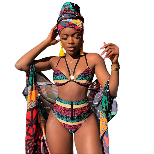 Woman wearing colorful African print bikinis with matching headwrap and shawl on white background