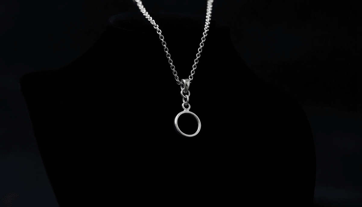 Minimalist silver necklace featuring a small circular pendant showcasing the best fashion jewelry trends 2024