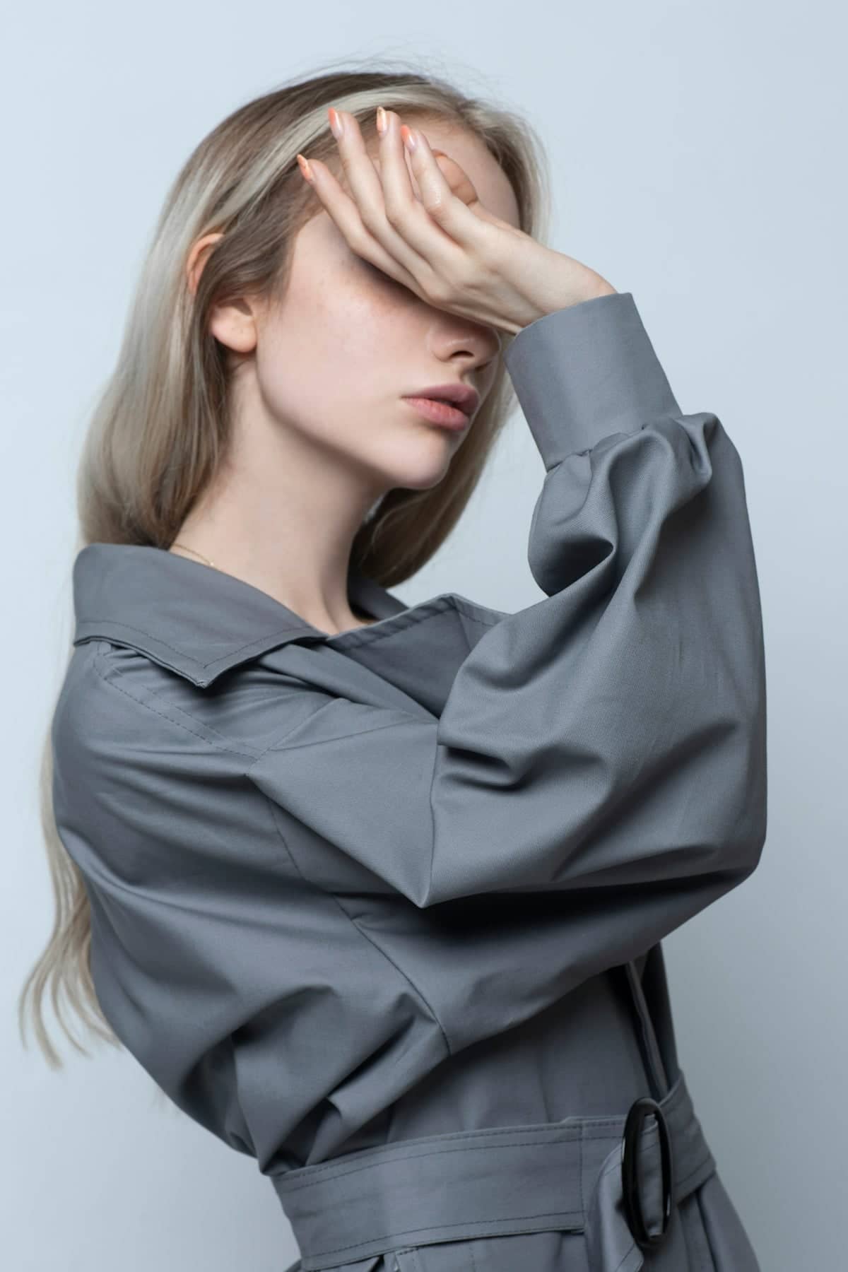 woman in black long sleeve shirt covering her face