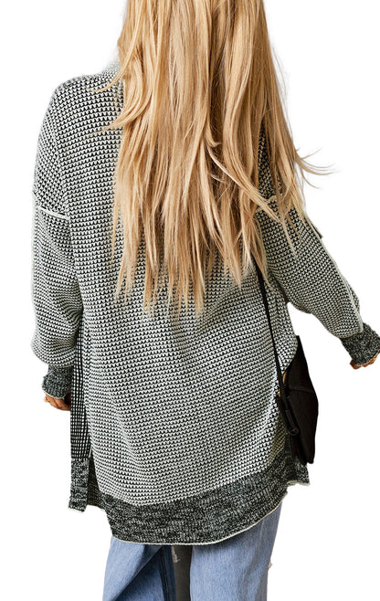 Back view of a gray plaid open front cardigan styled with relaxed jeans and long hair