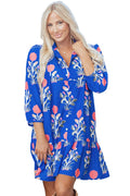 Woman wearing a blue floral dress in an outdoor setting
