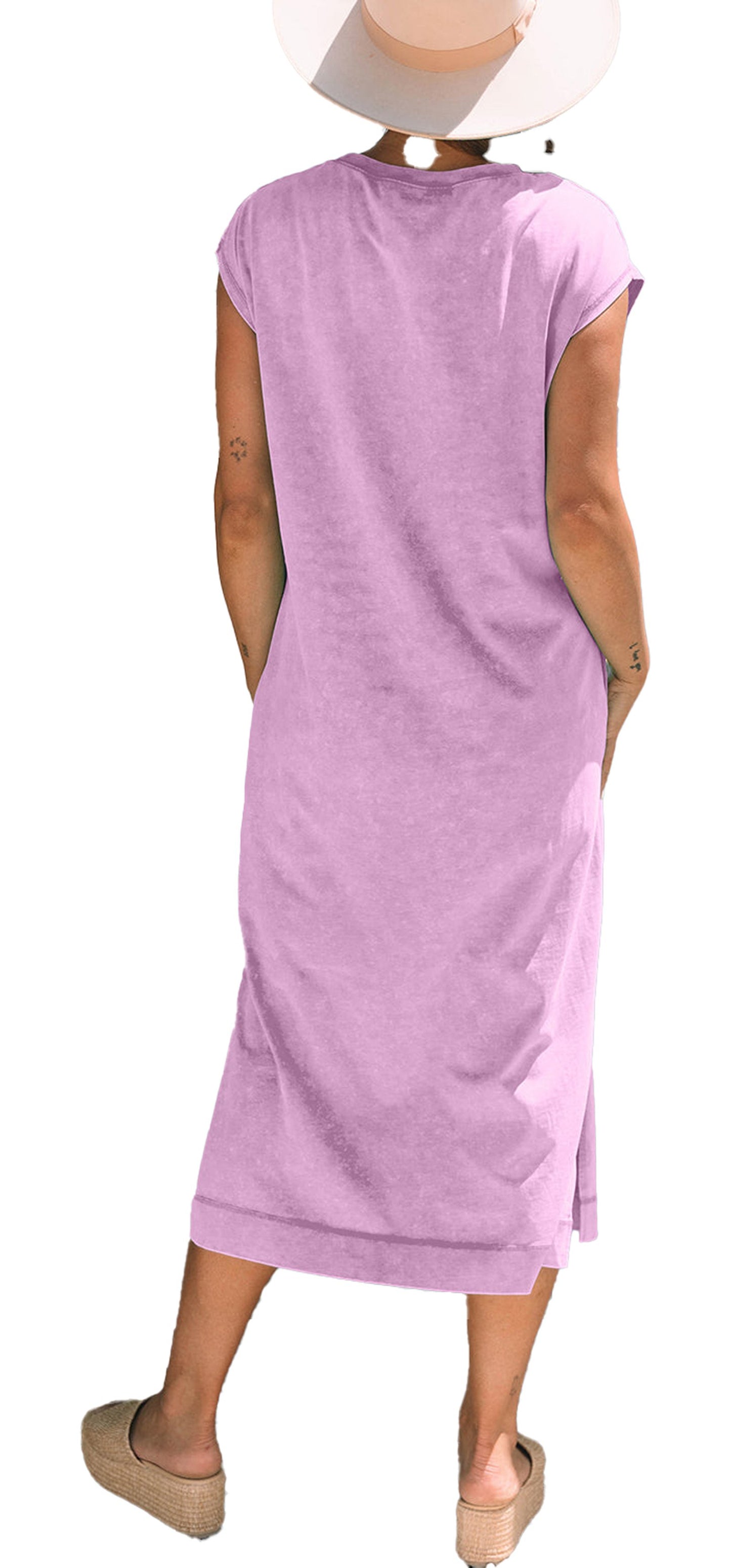 Back view of model wearing carrot mineral wash t-shirt dress in lavender H line midi style with short sleeves and side slits