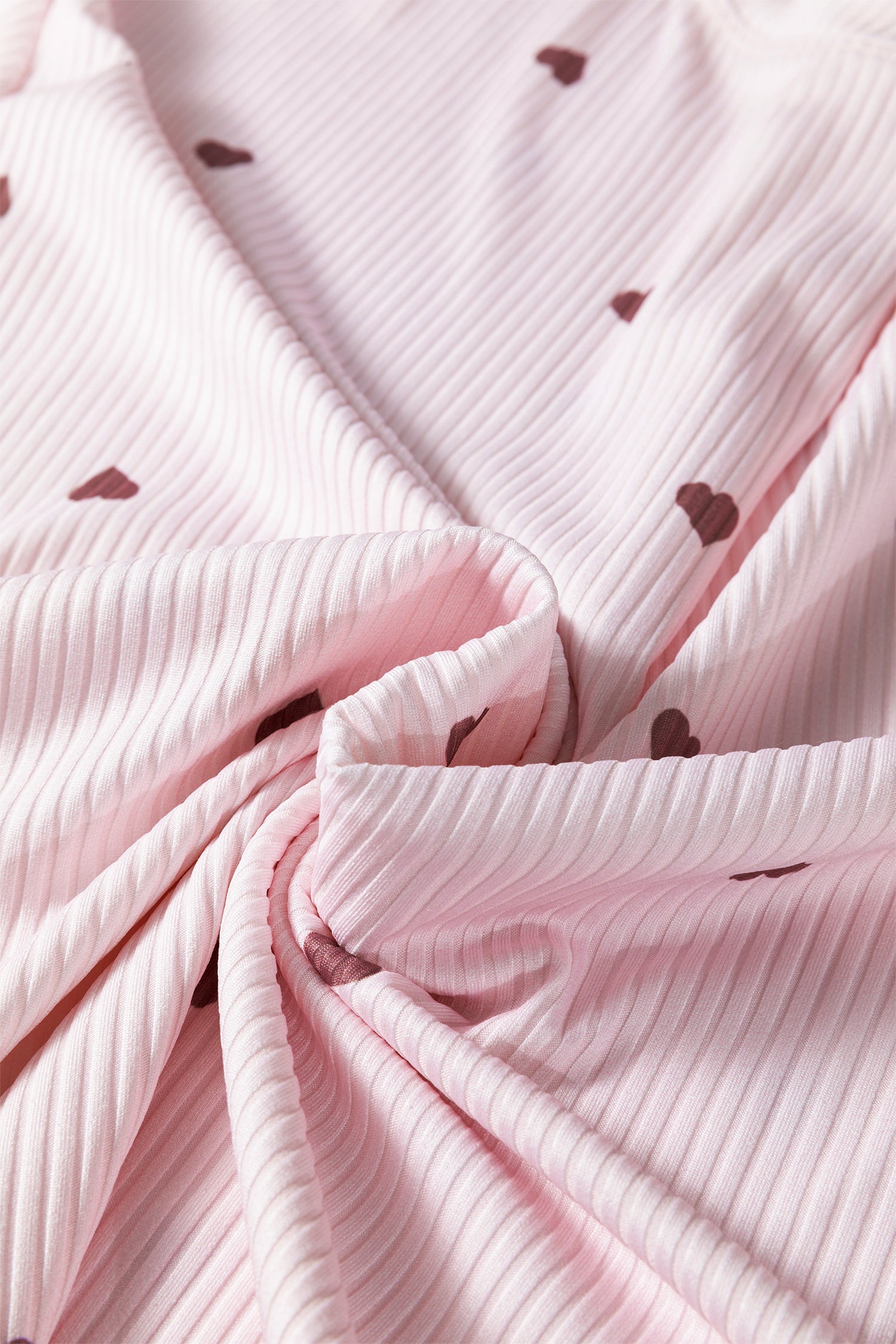 Soft pink lounge room set fabric with heart patterns and ribbed texture for comfy wear