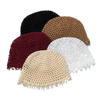 Five crochet hats in different colors on a light gray background