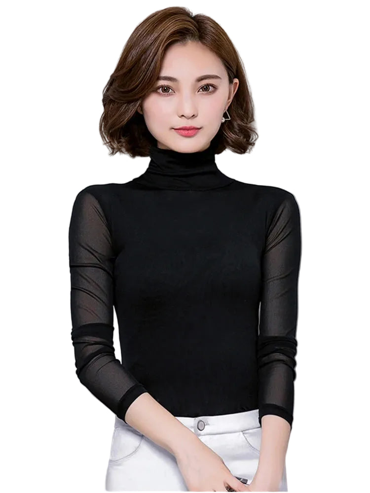 Woman wearing a black turtleneck with sheer sleeves against a gray background