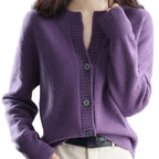 Purple knitted cardigan worn by a person with a blurred background