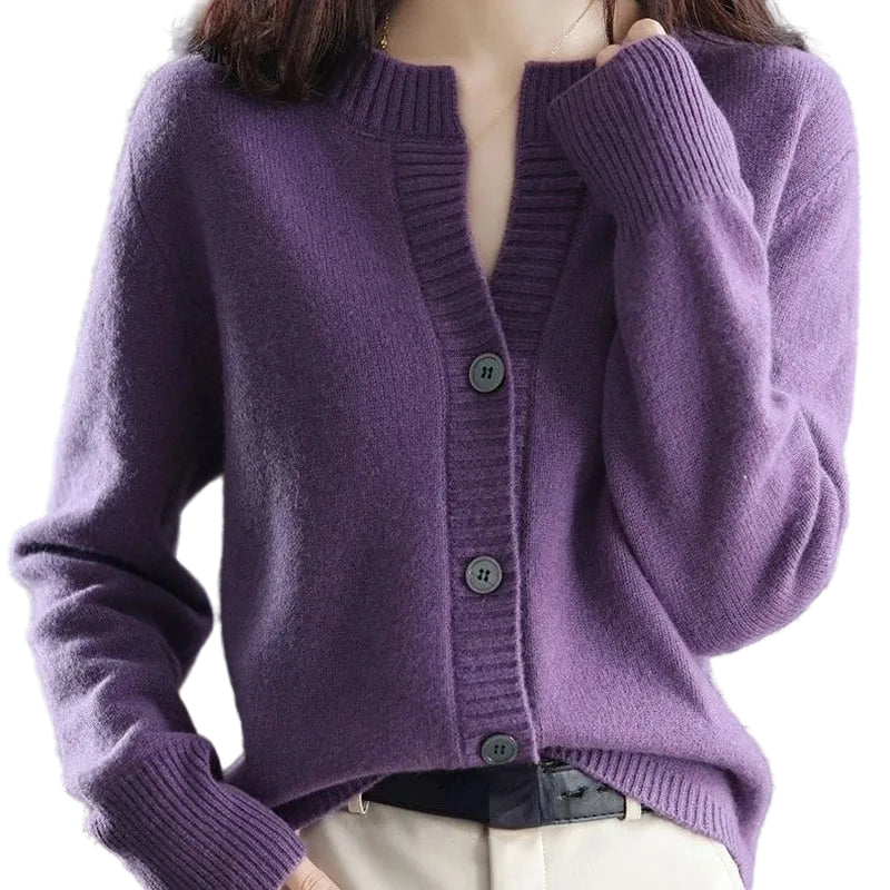 Purple knitted cardigan worn by a person with a blurred background