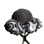 Handcrafted African hat with ruffle design in black and white colors for stylish headwear