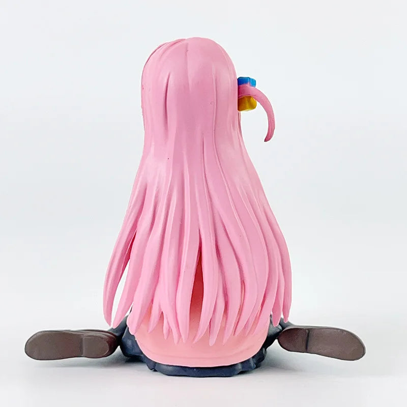 Back view of a cute anime figure with long pink hair and colorful accessories