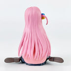 Back view of a cute anime figure with long pink hair and colorful accessories
