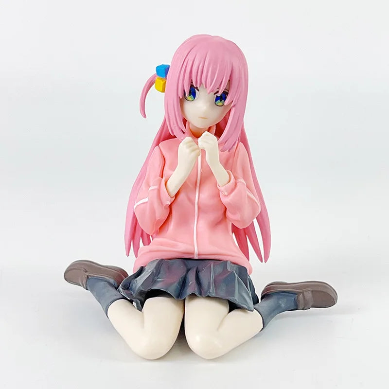 LuckeLadybug LLC anime figure of a girl with pink hair, wearing a pink hoodie and sitting down