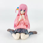 LuckeLadybug LLC anime figure of a girl with pink hair, wearing a pink hoodie and sitting down