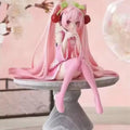 Anime figure of a pink-haired character sitting gracefully on a marble pedestal