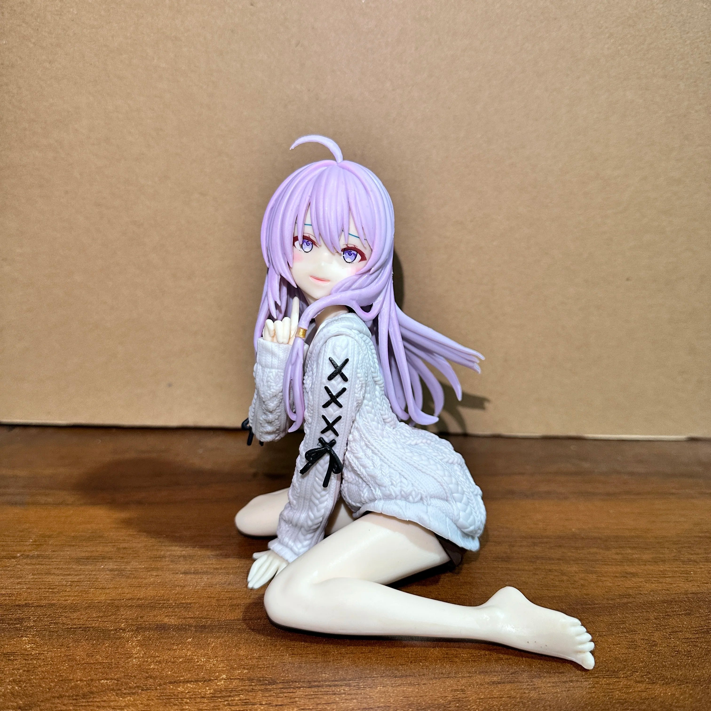Anime figure of a girl in a sweater, featuring long purple hair and a playful pose
