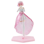 Anime figure of a girl with pink hair in a white dress and pink skirt, posed on a hexagonal base