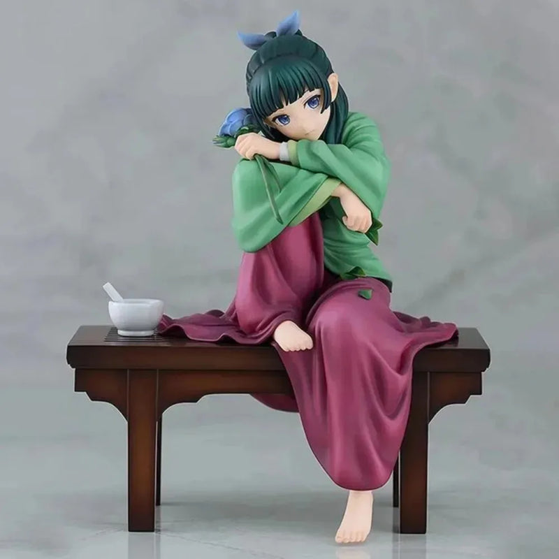 LuckeLadybug LLC anime figure of a girl sitting on a wooden table with a bowl and a blue flower