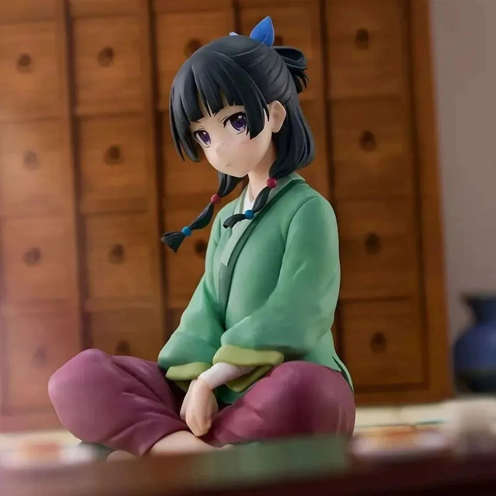 Anime figure of a girl sitting in traditional clothing with a serene expression by LuckeLadybug LLC