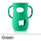Green silicone cover for baby bottle warmer with easy grip handles and playful design