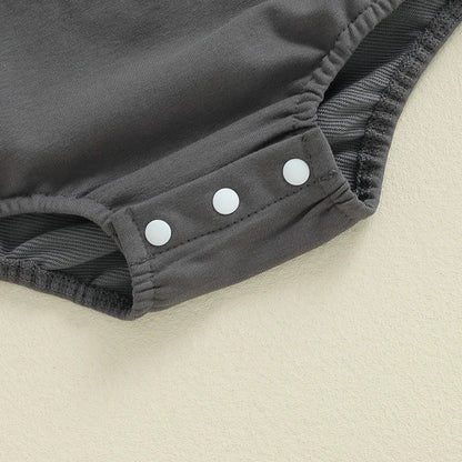 Close-up of grey baby boy Halloween romper with snap buttons for easy dressing
