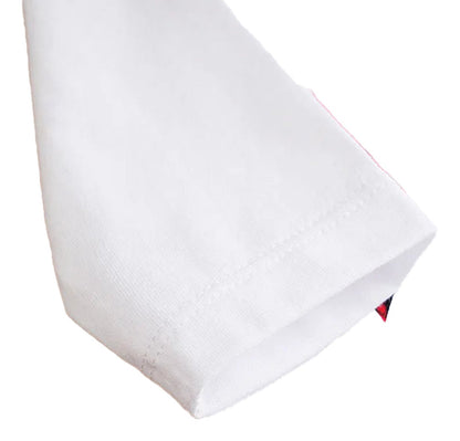 Close-up of a white sleeve from a baby Christmas outfit set featuring festive design elements