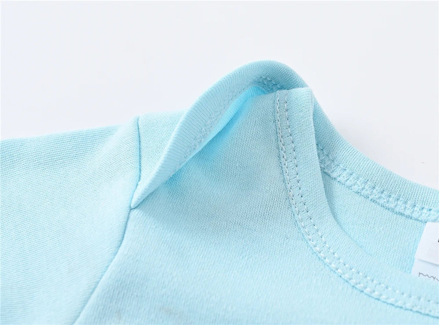 Light blue baby girl cotton romper set showing soft fabric and comfortable neckline detail