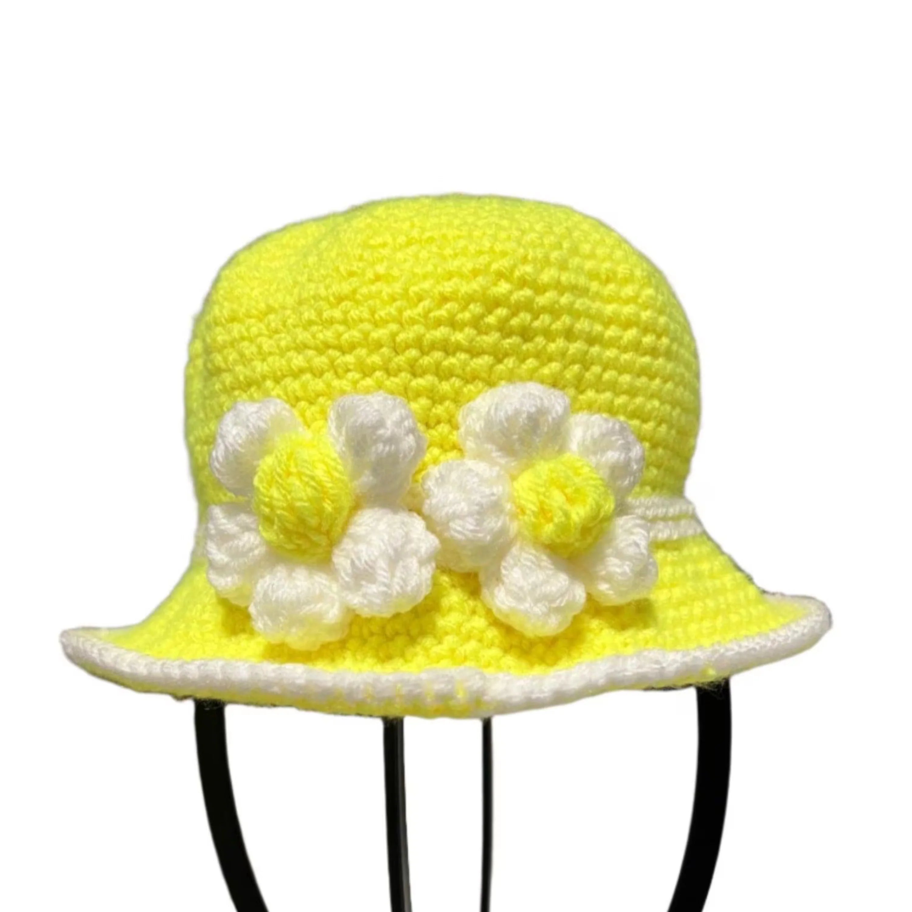Bright yellow baby hat with white flowers for sunny day outings