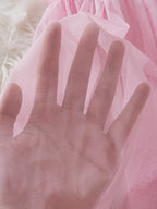 Close-up of soft pink fabric showcasing the sheer texture of a babydoll dress